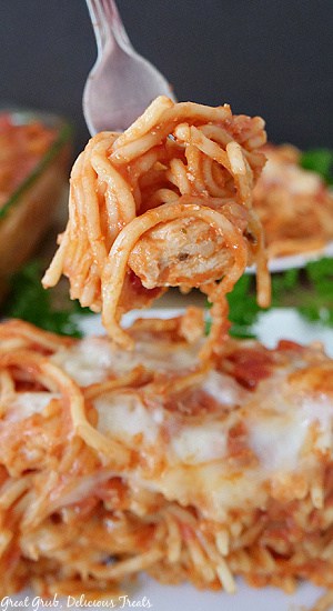 A forkful of spaghetti casserole with chicken.