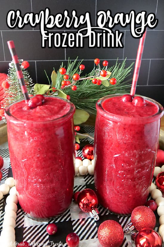 Two glasses filled with a frozen cranberry orange drink with black and red straws in them.