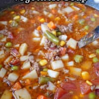 A large pot filled with vegetable soup.