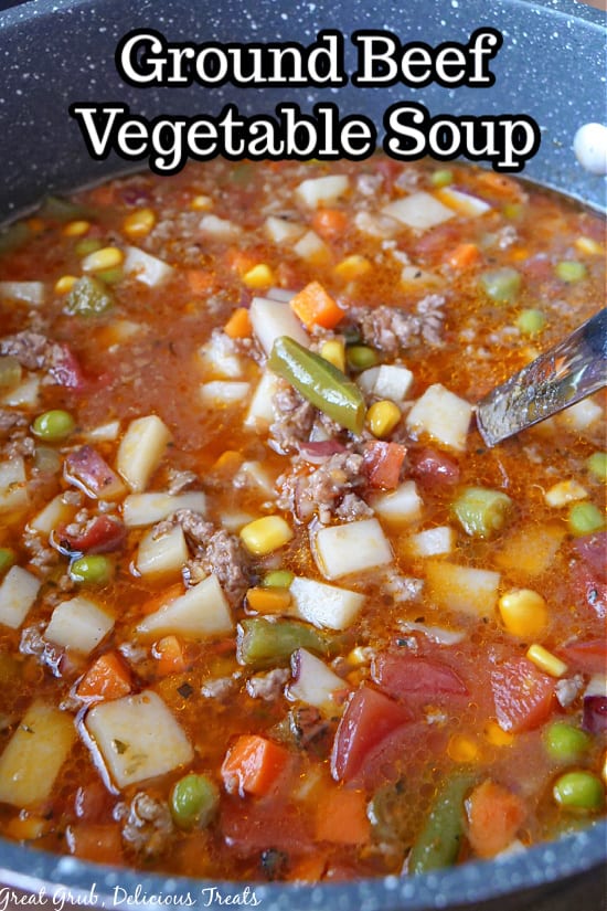 A large pot filled with vegetable soup with ground beef.
