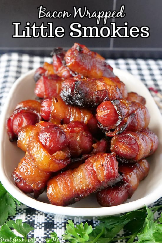A white bowl filled with bacon wrapped little smokies.
