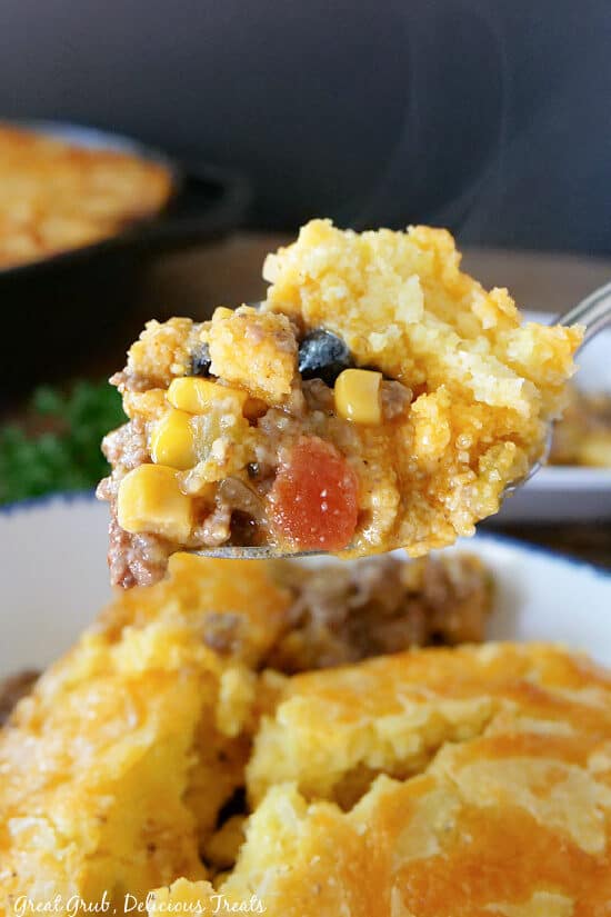 A close up picture of a bite of Tamale Pie on a spoon.