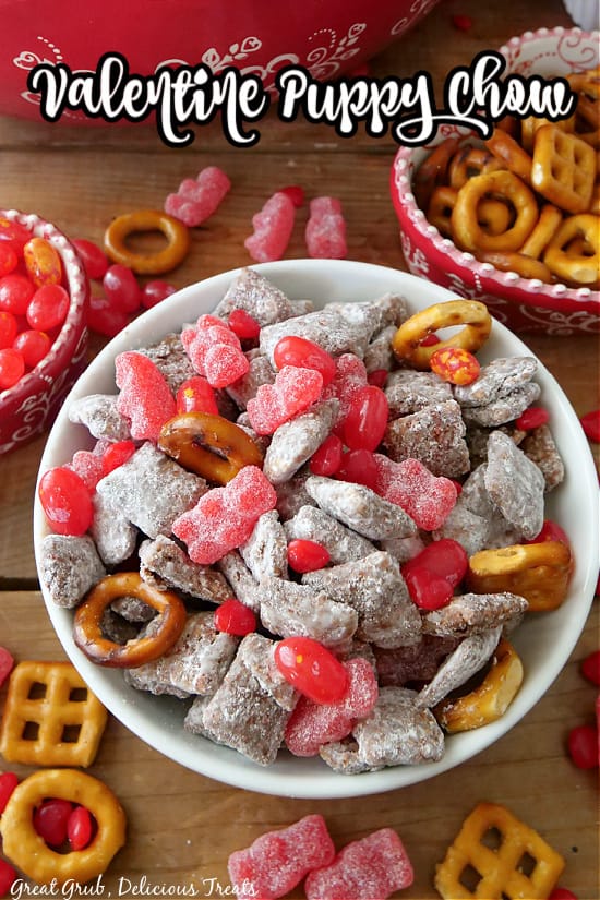 A white bowl filled with Valentine-themed puppy chow snack mix.