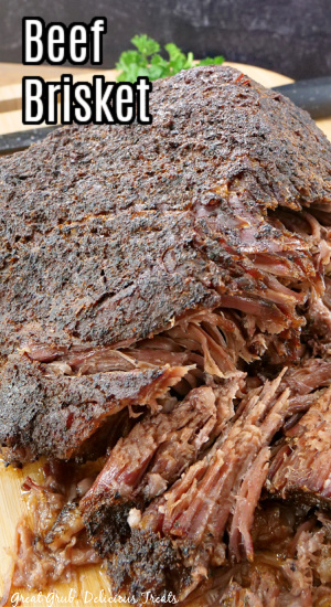 A close up of a beef brisket on a wood cutting board.