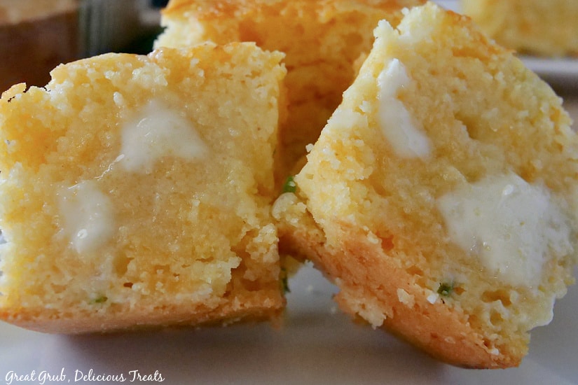 Two halves of cornbread with melted butter on it. 