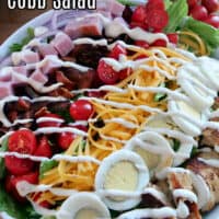 A white bowl filled with cobb salad.