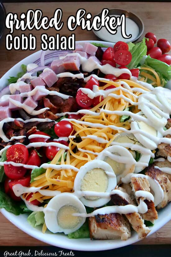 A white bowl filled with cobb salad.