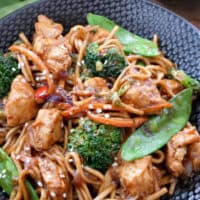 Chicken lo Mein in a black bowl.