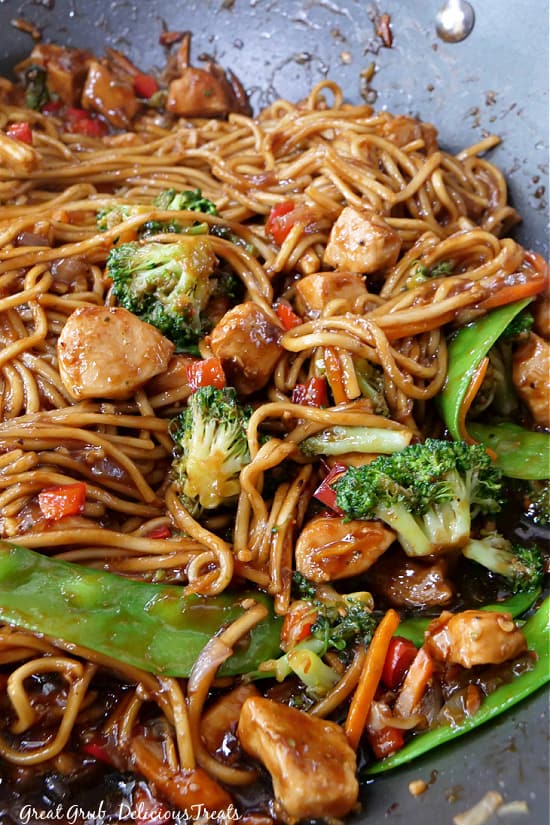 Chicken lo mein sitting in a large pan.