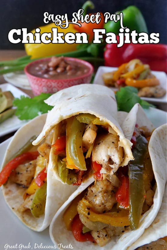 Three chicken fajitas stacked on a white plate, all filled with chicken, onions, and different colored bell peppers.
