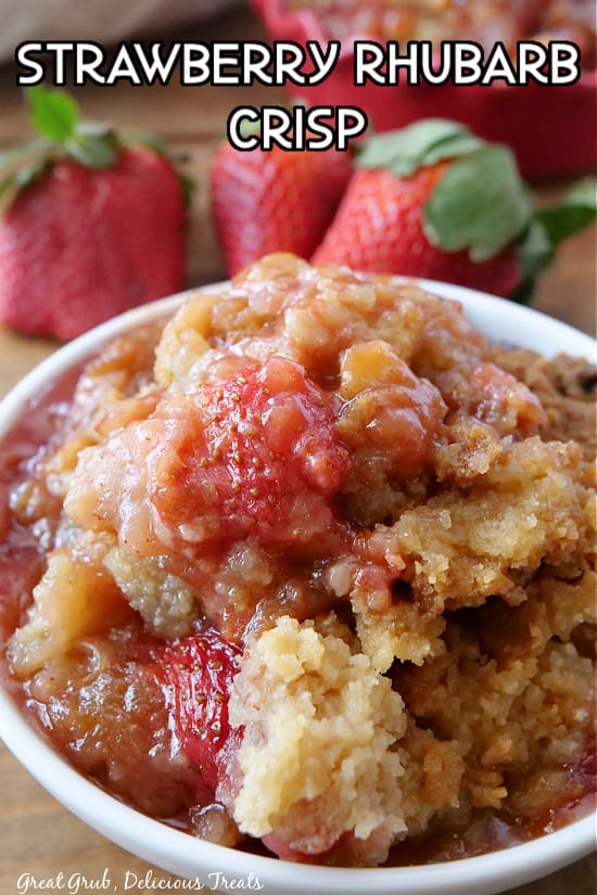 A white bowl filled with strawberry rhubarb crisp.