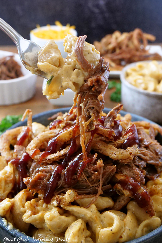 A big bite of brisket macaroni and cheese on a fork. 