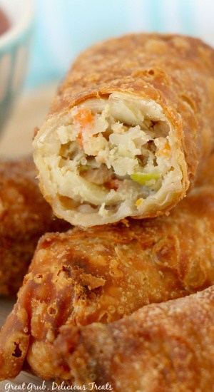 A close up of an egg roll with a bite taken out of it.