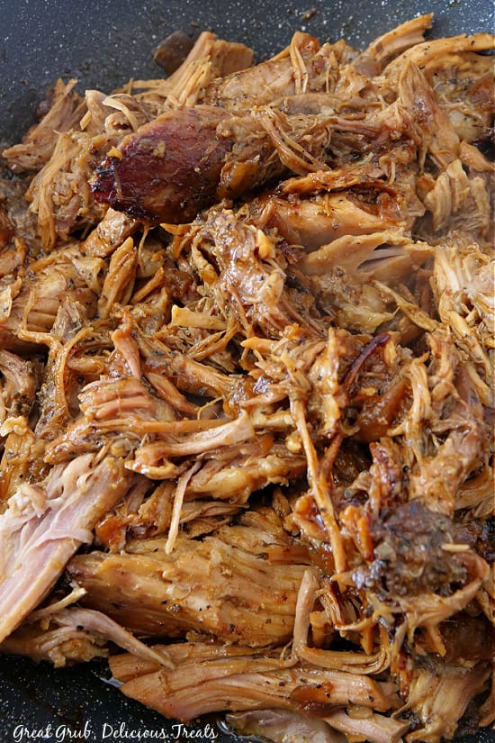 Shredded pulled pork in a large dutch oven.