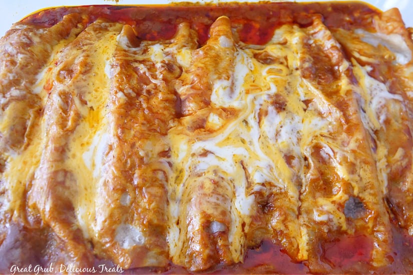 A 9 by 13 glass baking dish filled with homemade enchiladas.