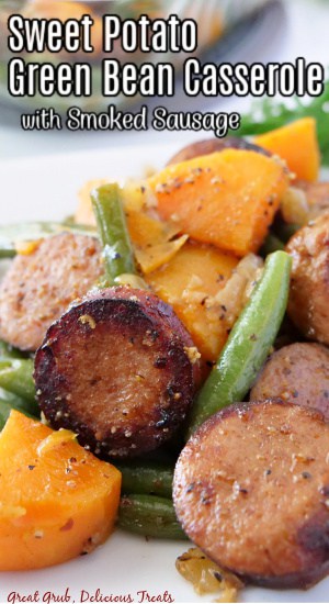 A close up of a serving of sweet potato, green beans, and smoked sausage.