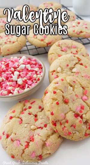 A white surface with Valentine's Day sugar cookies on it.