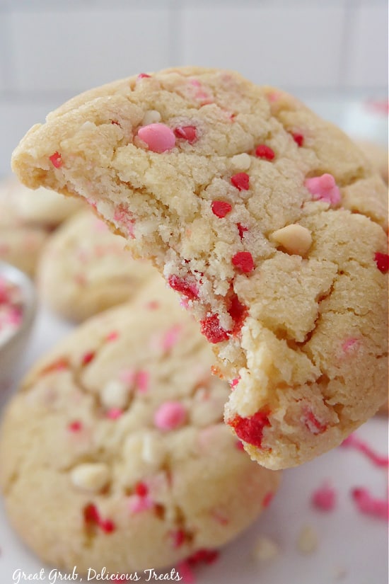 A close-up picture of a sugar cookie with a bite taken out.