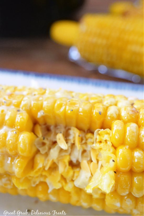 A super close up shot of an ear of corn with a bite taken out of it.