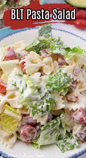 A white bowl with blue trim filled with BLT pasta salad.