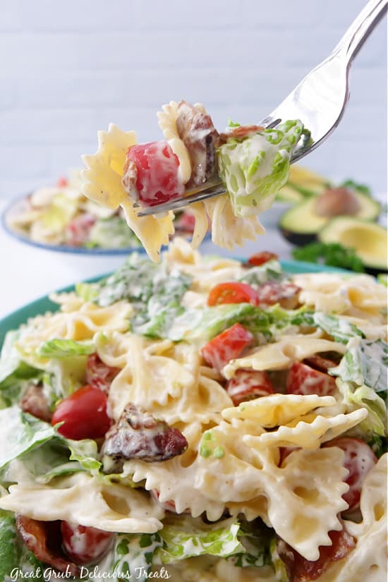 A big bite of BLT pasta salad on a fork.