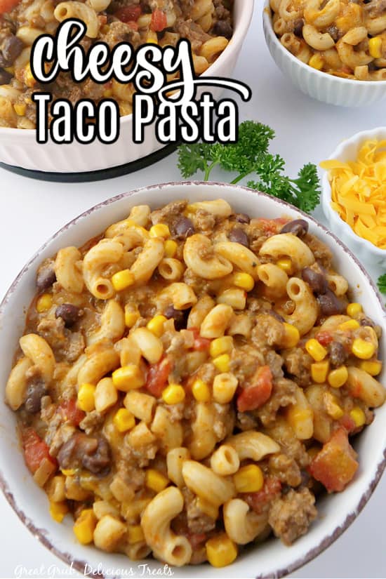 A close up photo of a white bowl with brown trim filled with taco pasta, with the title at the top of the pic.