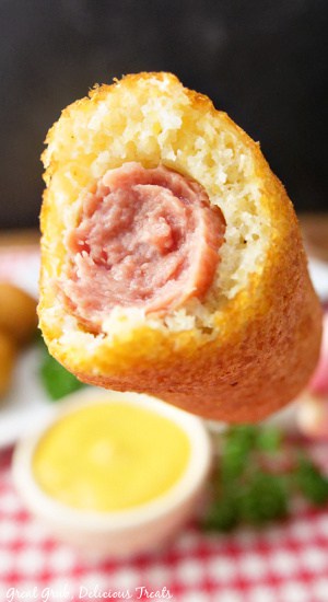 A corn dog with a bite taken out of it. 