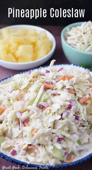 A white bowl with blue trim filled with a serving of pineapple slaw.