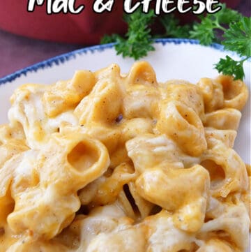 A white bowl with blue trim loaded with mac and cheese.