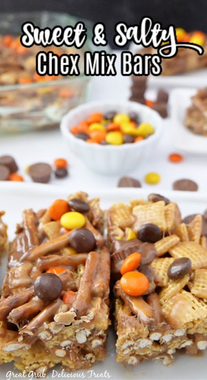 A white plate with Chex mix bars with Reese's chocolate.