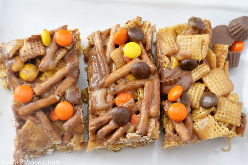A white plate with three Sweet and Salty Chex mix bars on it.