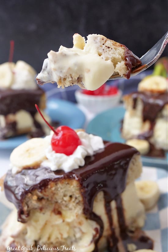 A bite of ice cream cake being held up on a fork.