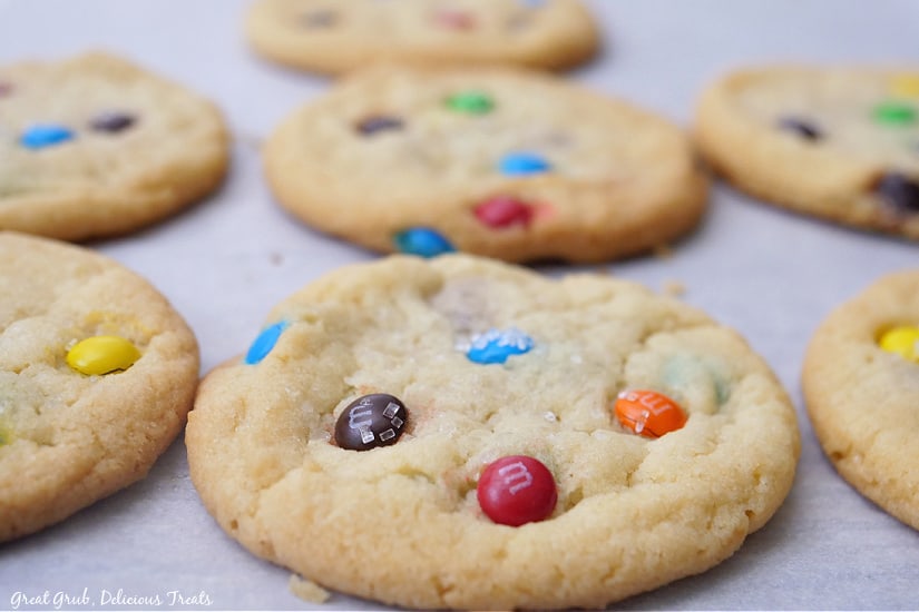 A baking sheet with freshly baked M&M sugar cookies on it.