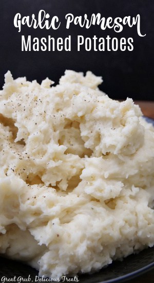 A serving of mashed potatoes in a big black bowl.