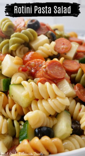 A close up of a white bowl filled with pasta salad.