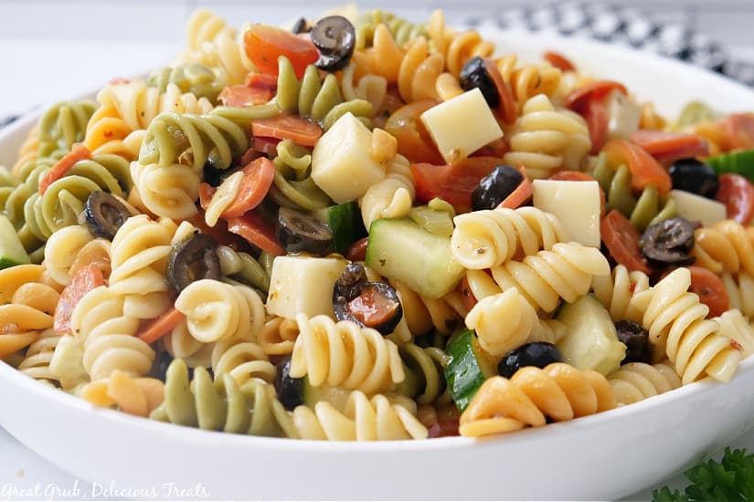 A white bowl with pasta salad in it.