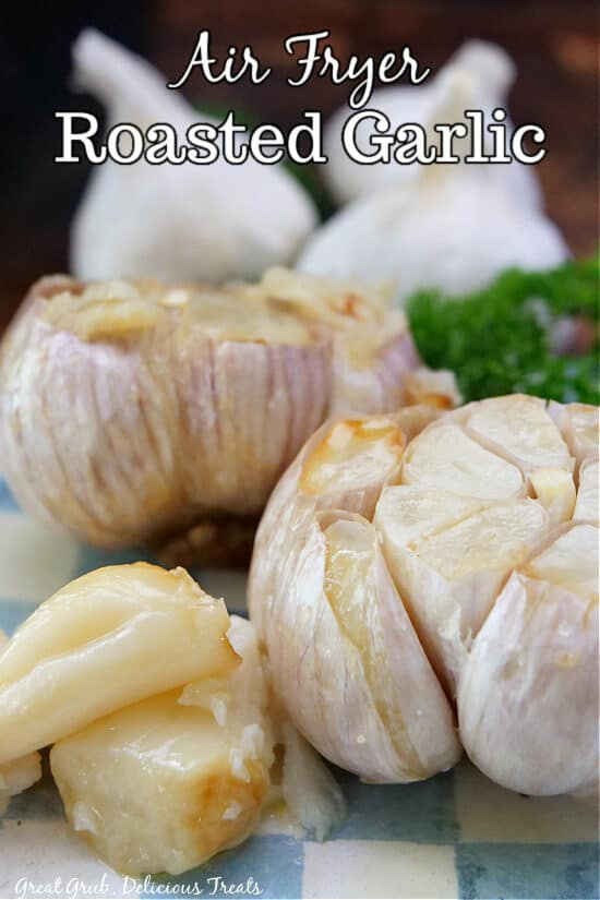 Two bulbs of roasted garlic on a blue and white plate,