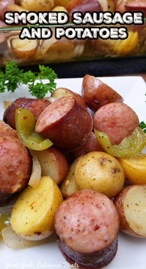 A white plate with smoked sausage chunks and bite-size potatoes on it.
