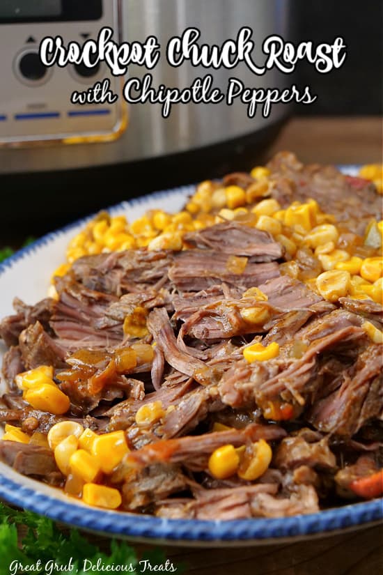 A white plate with blue trim with chuck roast, corn and peppers.