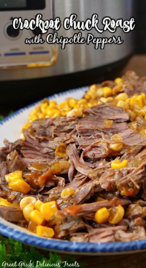 A large plate with corn and chuck roast on it.