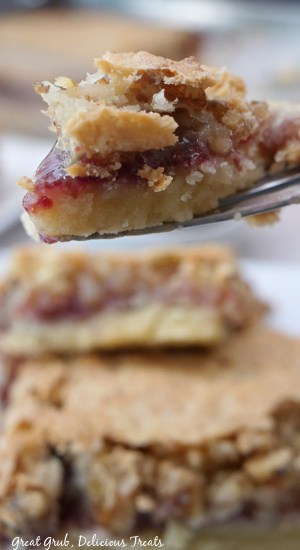 A close up of a bite of raspberry coconut bar on a fork.