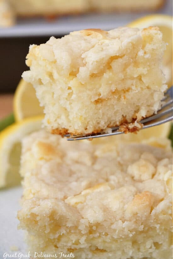 A close up photo of a bite of lemon coffee cake on a fork.