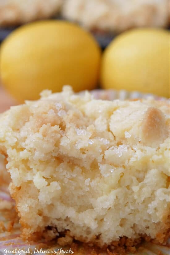 A close up of a lemon muffin with a bite taken out of it.