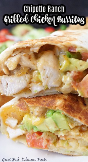 A close up of a grilled chicken burrito cut in half, stacked on top of each other showing the inside ingredients of the burrito.