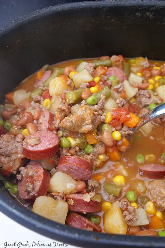 A black Dutch oven with cowboy stew in it.