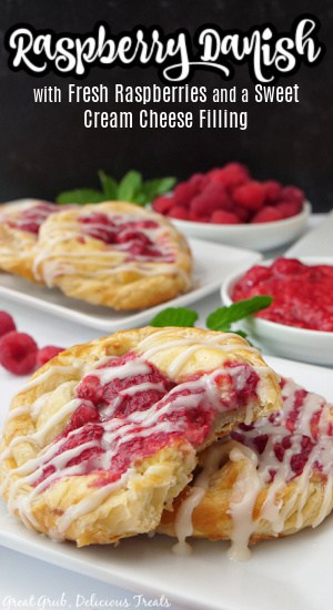 Four raspberry Danishes on two white plates.