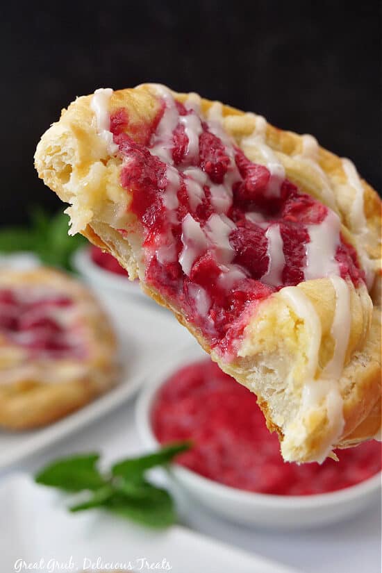 A close up of a Danish pastry with a bite taken out of it.