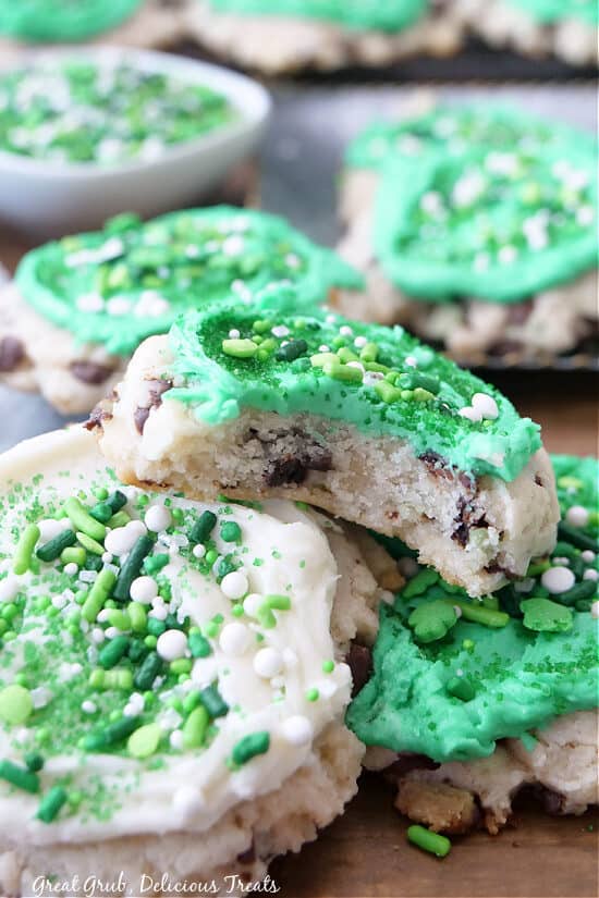 A few St Patrick's Day cookies stacked on top of each other with a bite taken out of one of them.