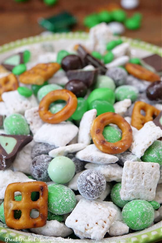 A close up of St Patrick's day muddy buddies mix in a great and white bowl.