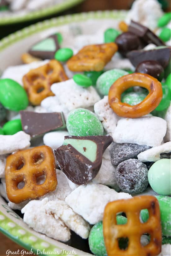 A close up of a bowl filled with St Patrick's Day Muddy Buddies cereal mix.